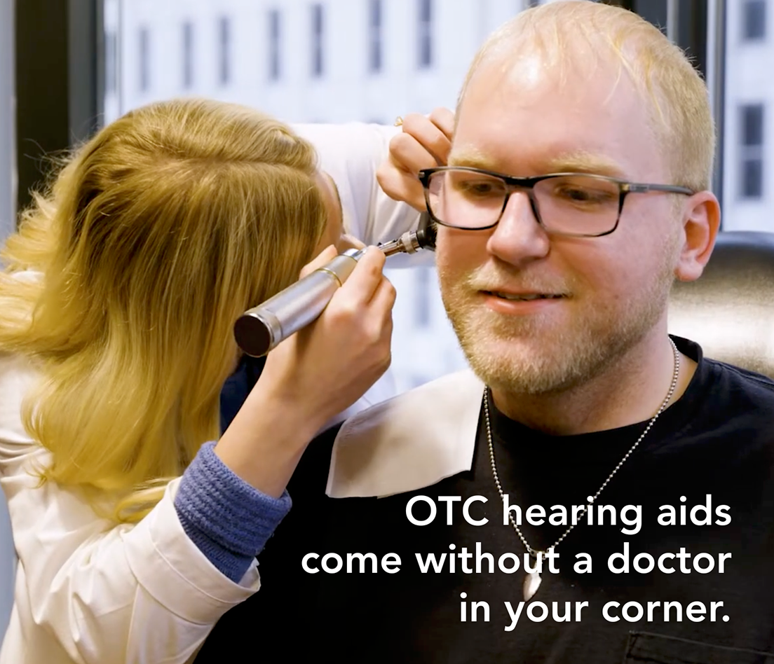 Hearing specialist fits OTC hearing aids for a patient in a clinic setting.