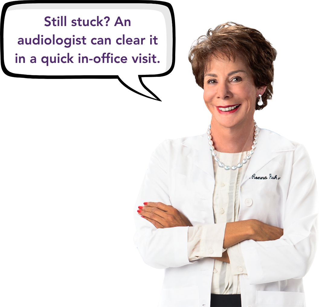 2 when to see an audiologist - Hearing Health Center Smiling audiologist in a white coat with arms crossed, speech bubble says,'Still stuck? An audiologist can clear it in a quick in-office visit.'